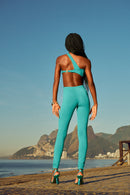 Rear view of the Celestina jumpsuit showing the asymmetrical strap, gold-tone back clasp, and sleek high-waisted fit.