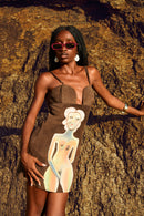Front view of the Coincidencia brown suede paneled mini dress featuring hand-painted urban figures by @basugiart.