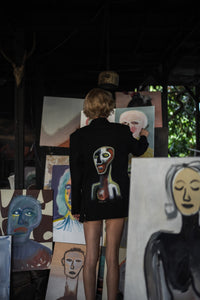 "Coincidencia?" Denim Blazer - Punta Loca  Elevate your ensemble with the "Coincidencia?" Oversized Blazer, a harmonious blend of Punta Loca's signature tailoring and the artistic genius of @basugiart. Crafted from premium black denim, this blazer showcases pronounced shoulders, peak lapels, and functional flap pockets. Each blazer becomes a canvas, adorned with hand-painted figures that echo the vibrancy of street art. 