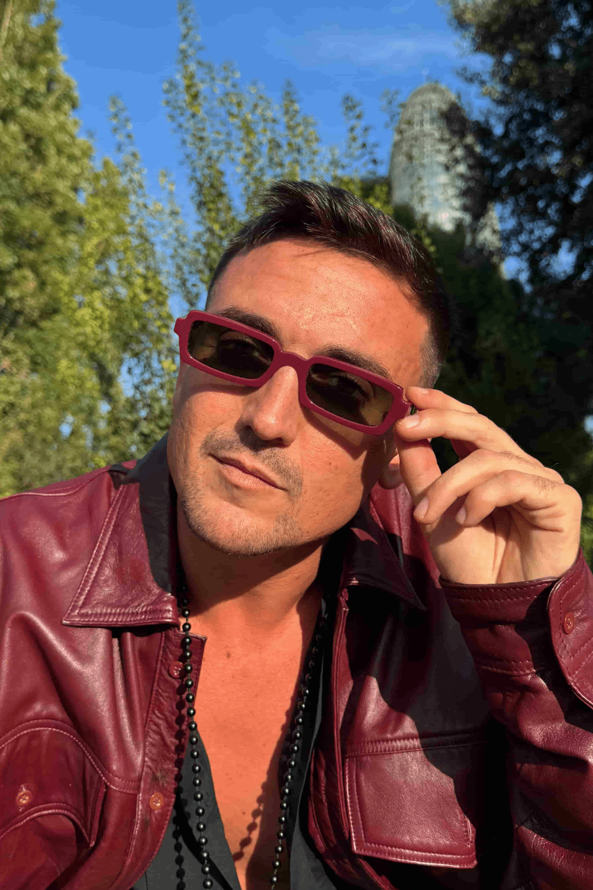 Man wearing Singularidad burgundy handmade Italian sunglasses — Punta Loca eyewear